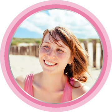 Young mother smiling on the beach.